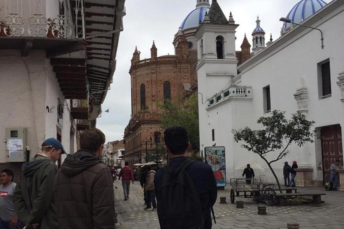 a group of people walking down a street with a building