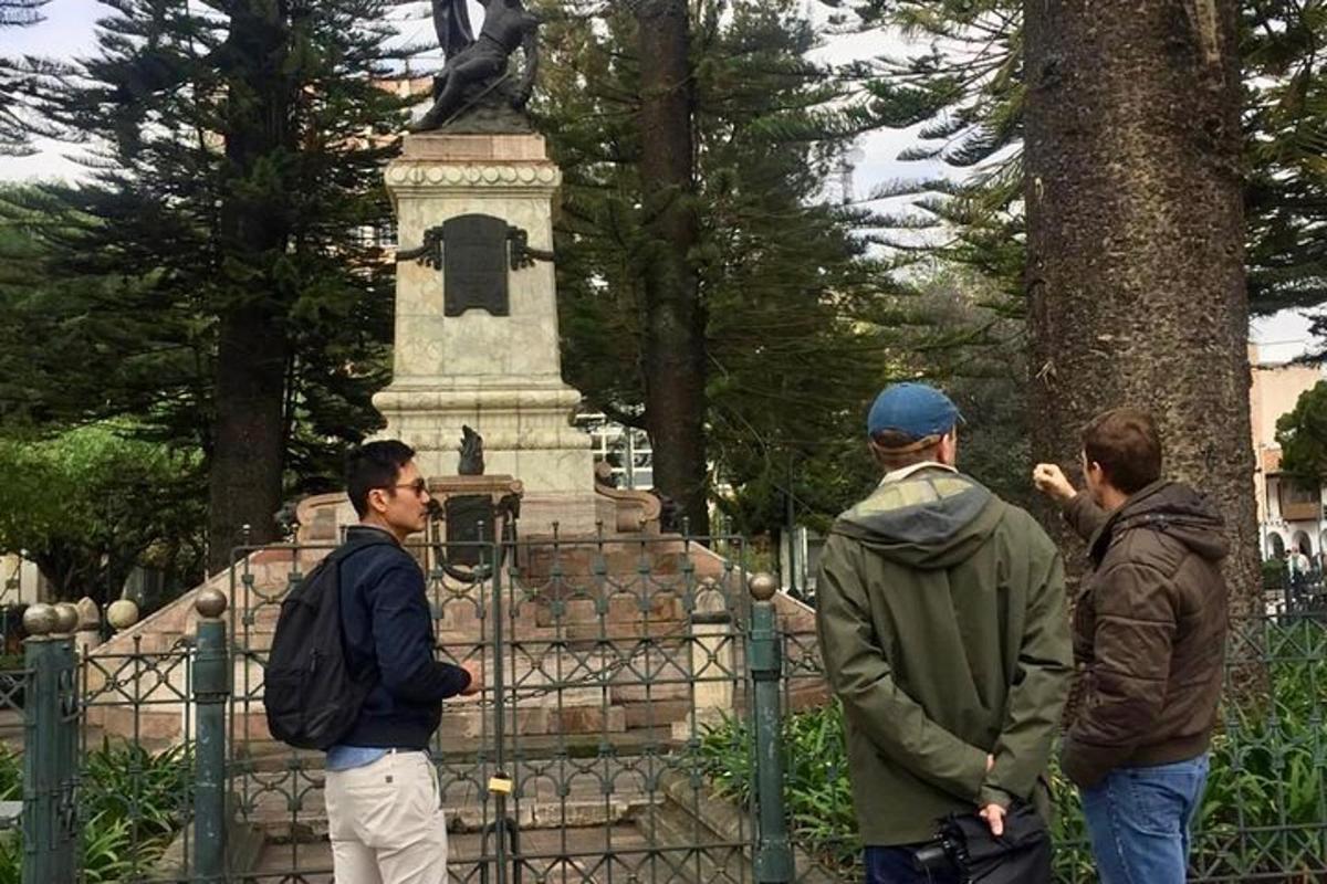 a group of men standing in front of a statue