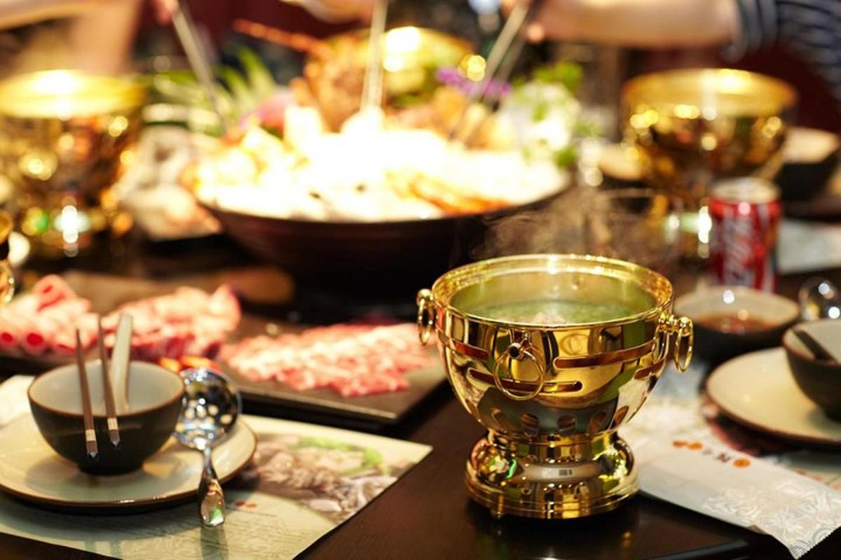 a gold trophy on a table with plates and spoons