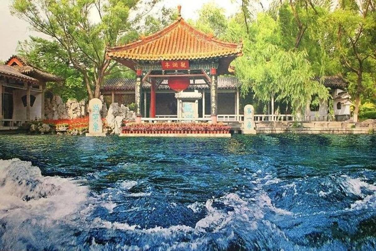 a building with a pool of water in front of a temple