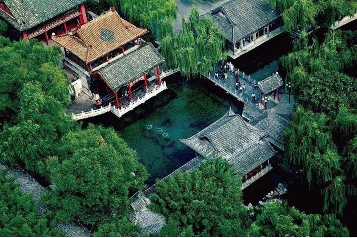 an overhead view of a building with water and trees