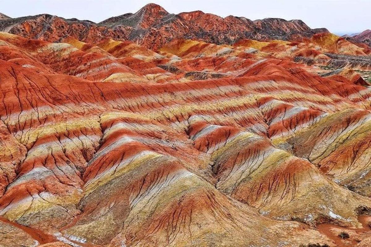 a painting of a mountain with red rocks