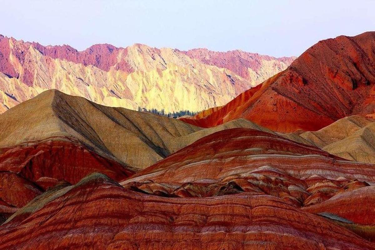 a painting of a desert with red and brown mountains