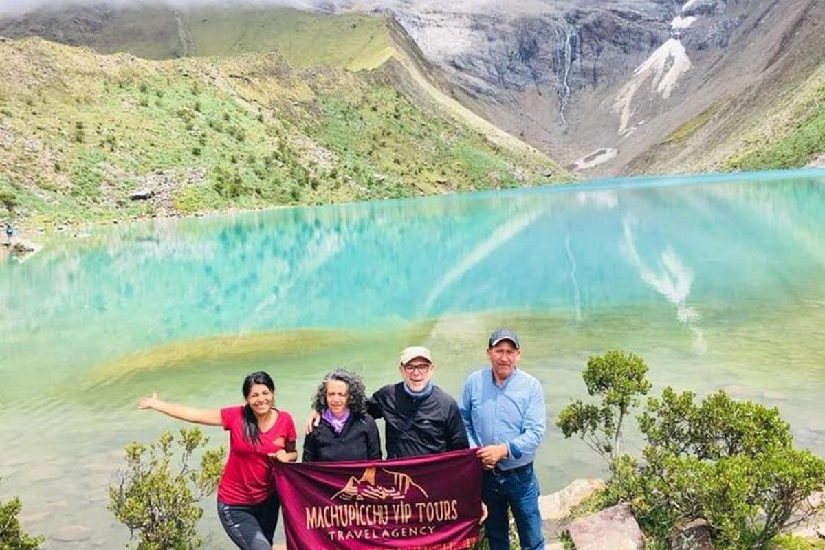 a group of people holding a banner in front of a mountain
