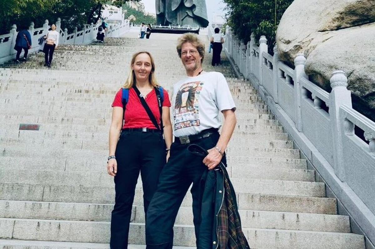 a man and a woman standing on the stairs