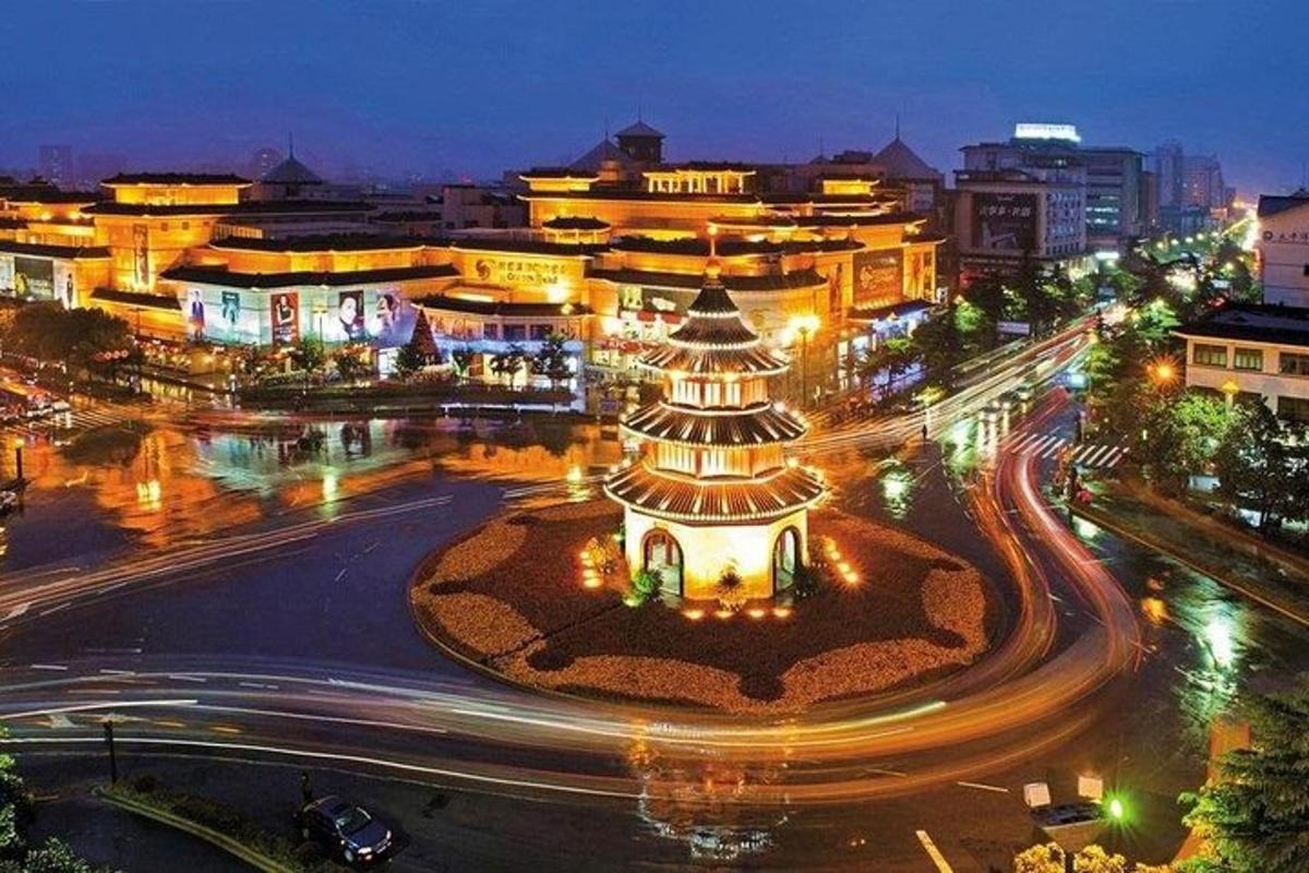 a city lit up at night with a building