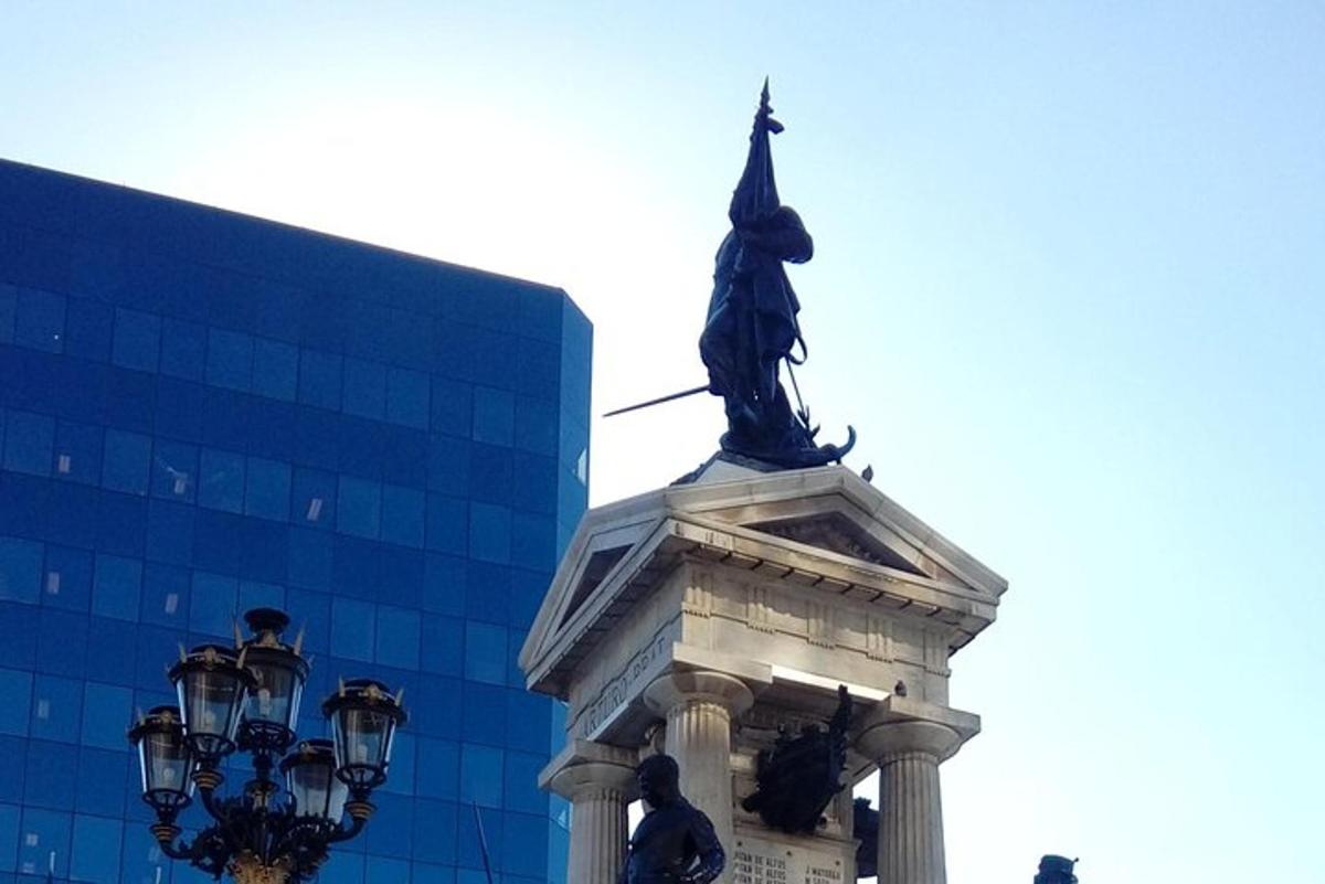 a statue on top of a building with a street light