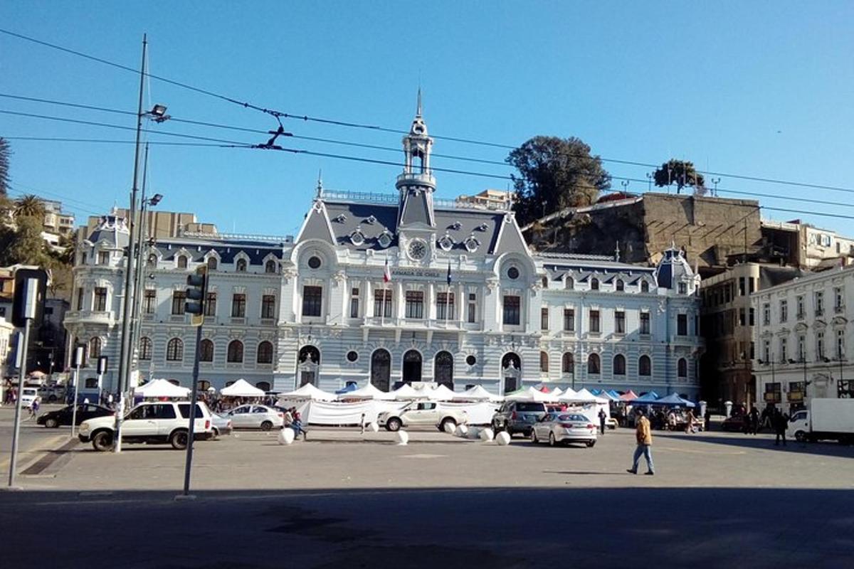 a large white building with cars parked in a parking lot