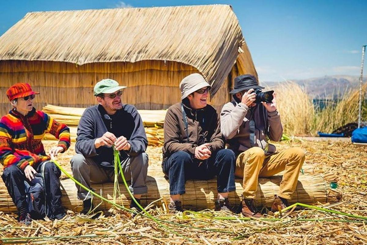 a group of people sitting in front of a hut