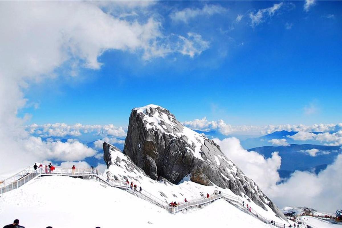 a group of people on top of a snow covered mountain