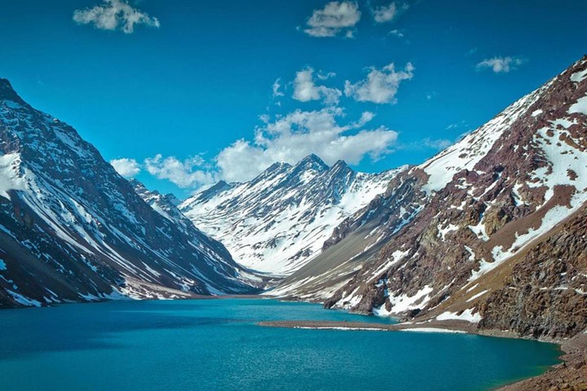 a lake in the middle of a snow covered mountain