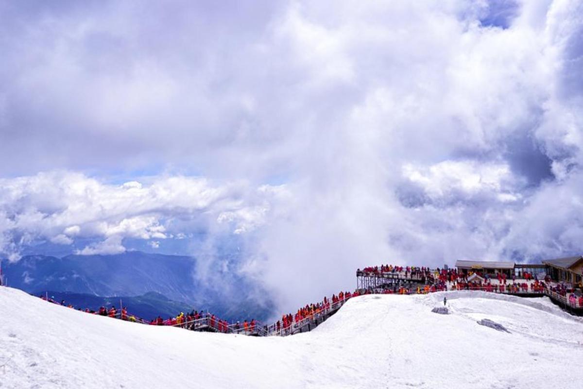 a crowd of people standing on top of a snow covered slope
