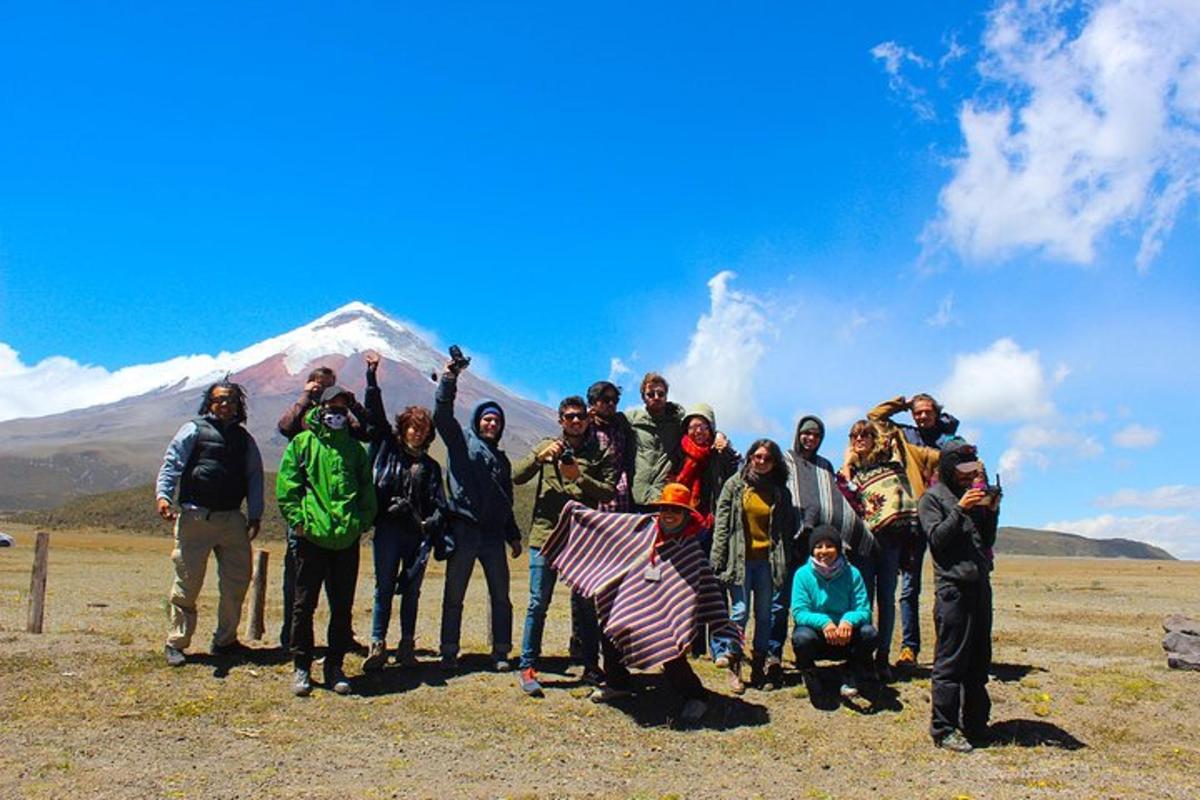 a group of people standing in front of a mountain
