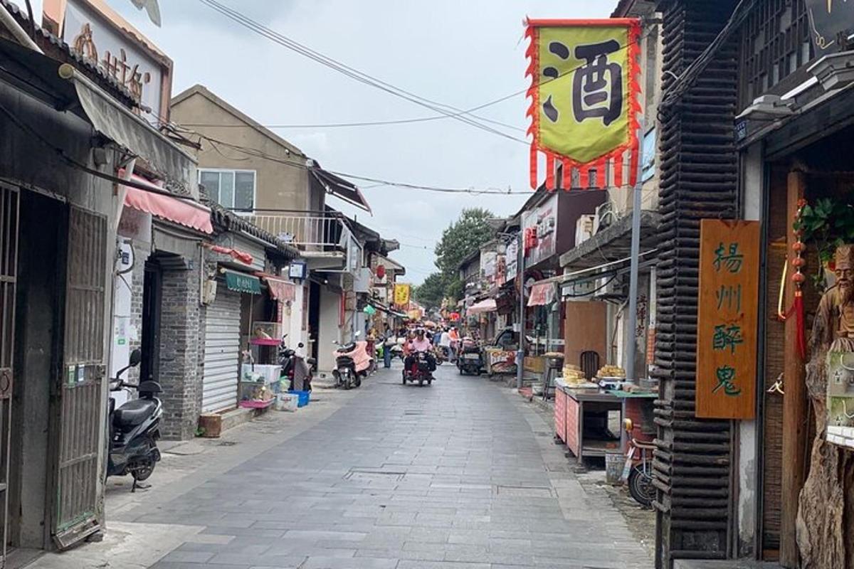 an alley with people riding motorcycles down a street