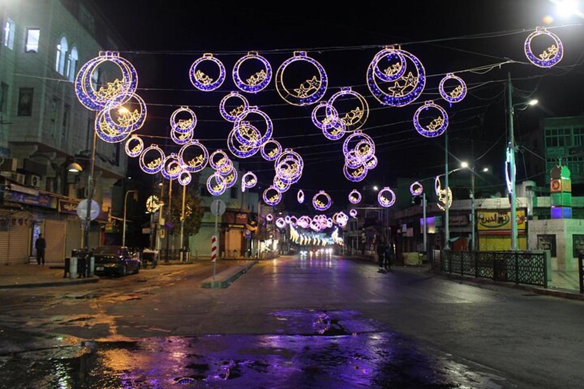 a street with christmas lights hanging over a street