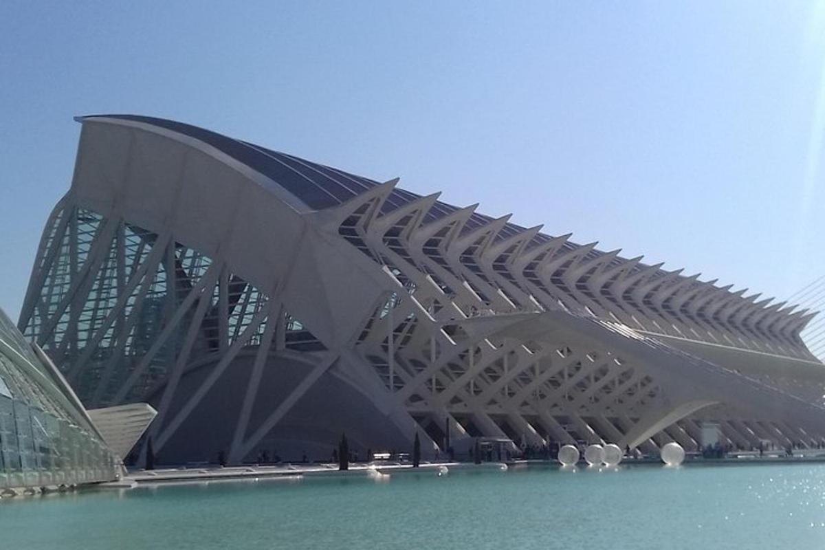 a large building with a curved roof in the water
