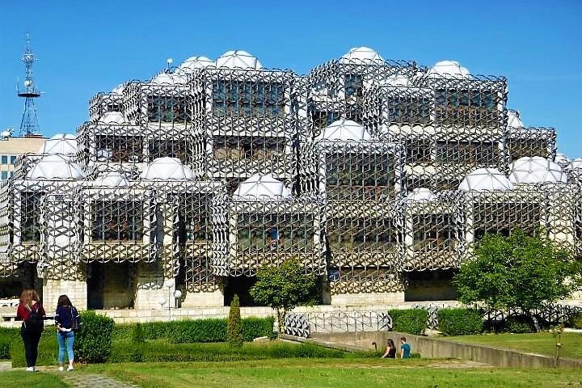 a large building with people standing in front of it