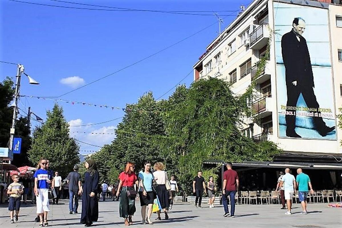 a group of people walking down a city street