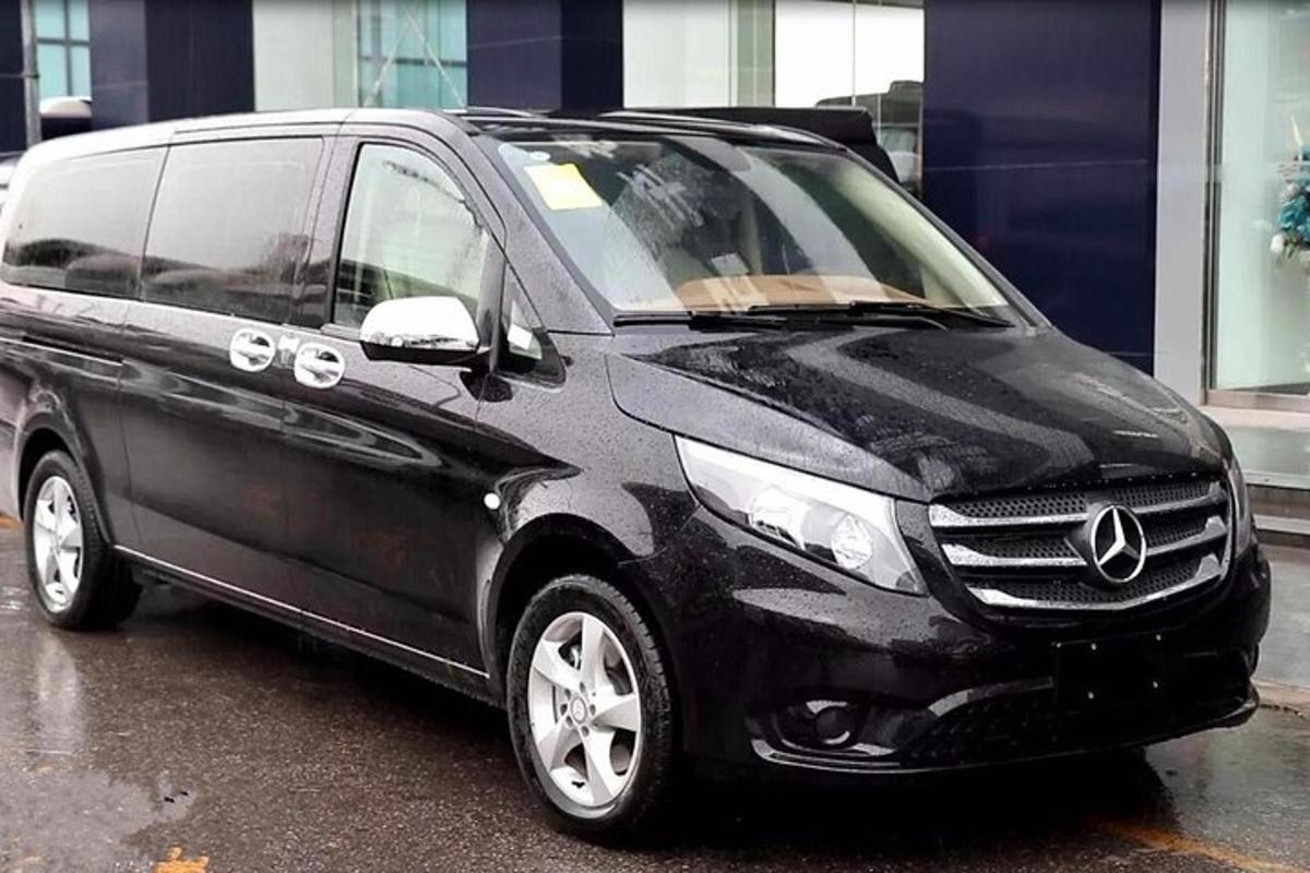 a black minivan parked in a parking lot