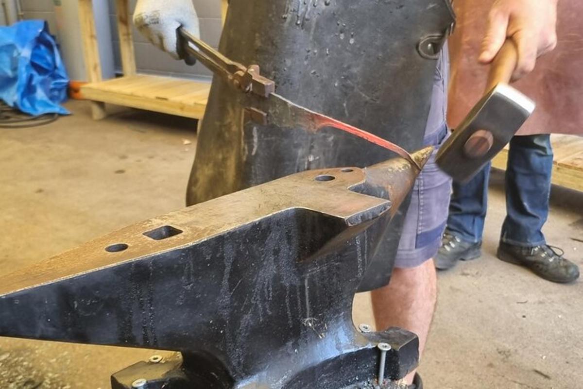 a man is cutting something with a pair of scissors