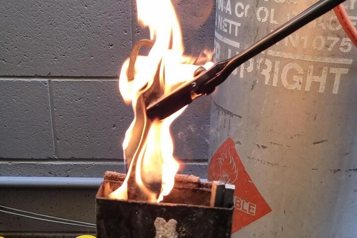 a pot of fire with a stick in it