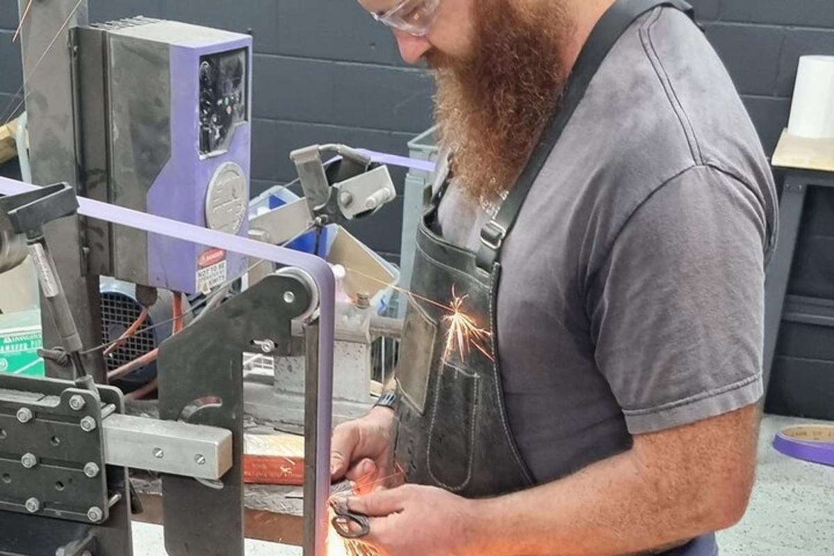 a man with a beard working on a machine