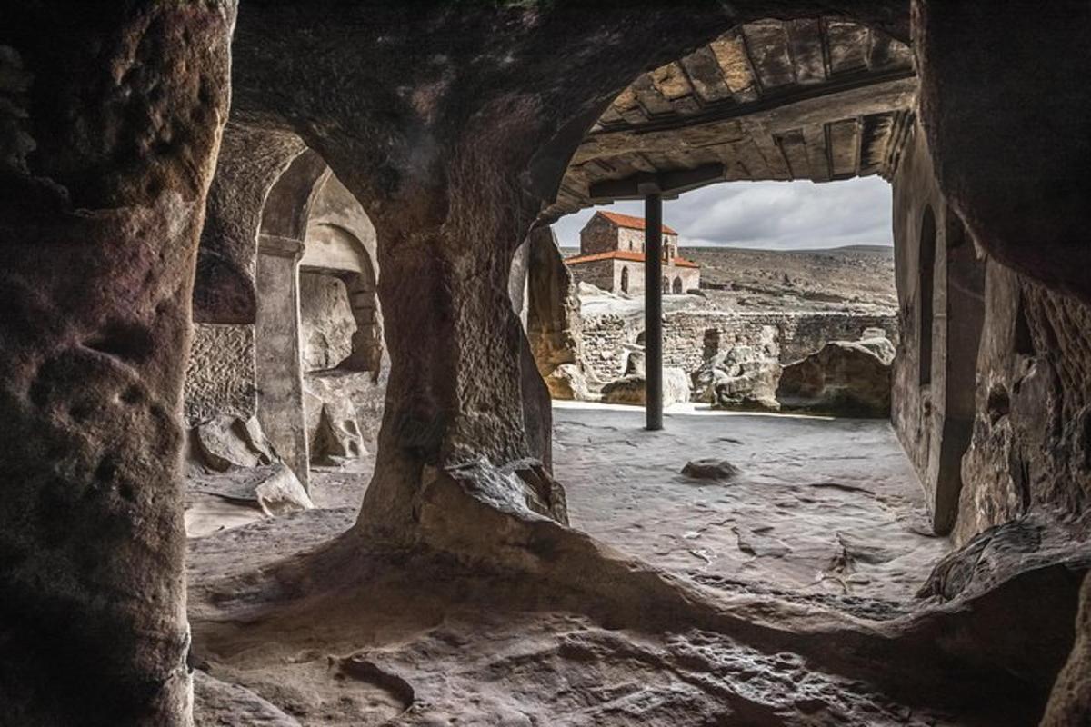 a view of a building through a stone archway