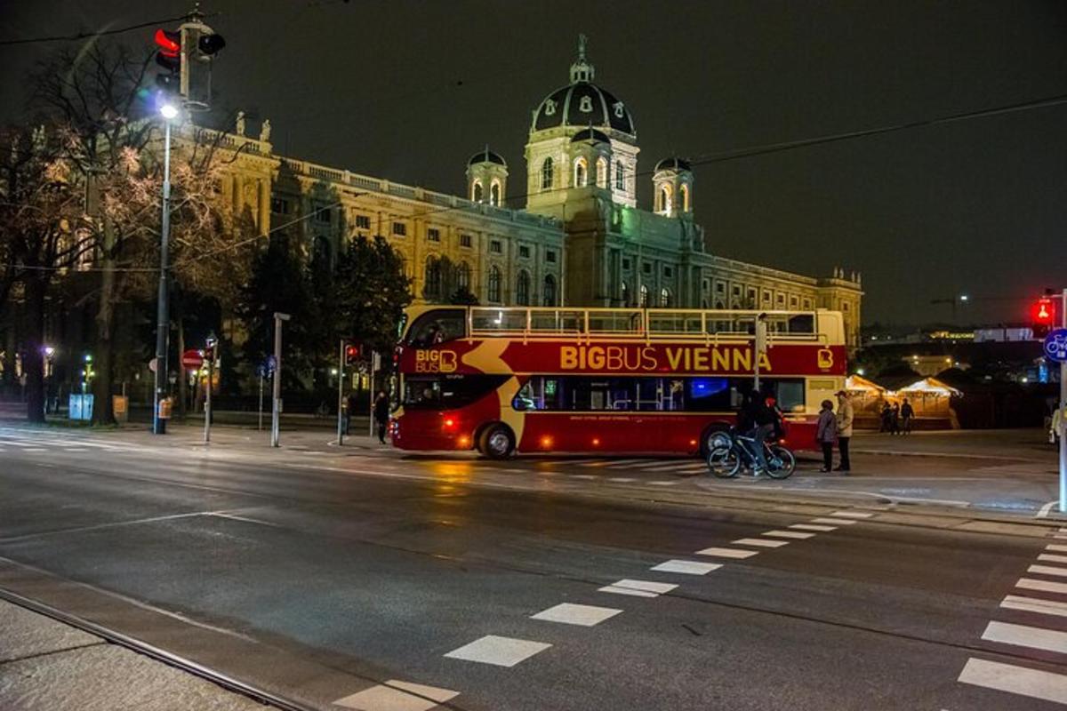a red double decker bus parked in front of a building
