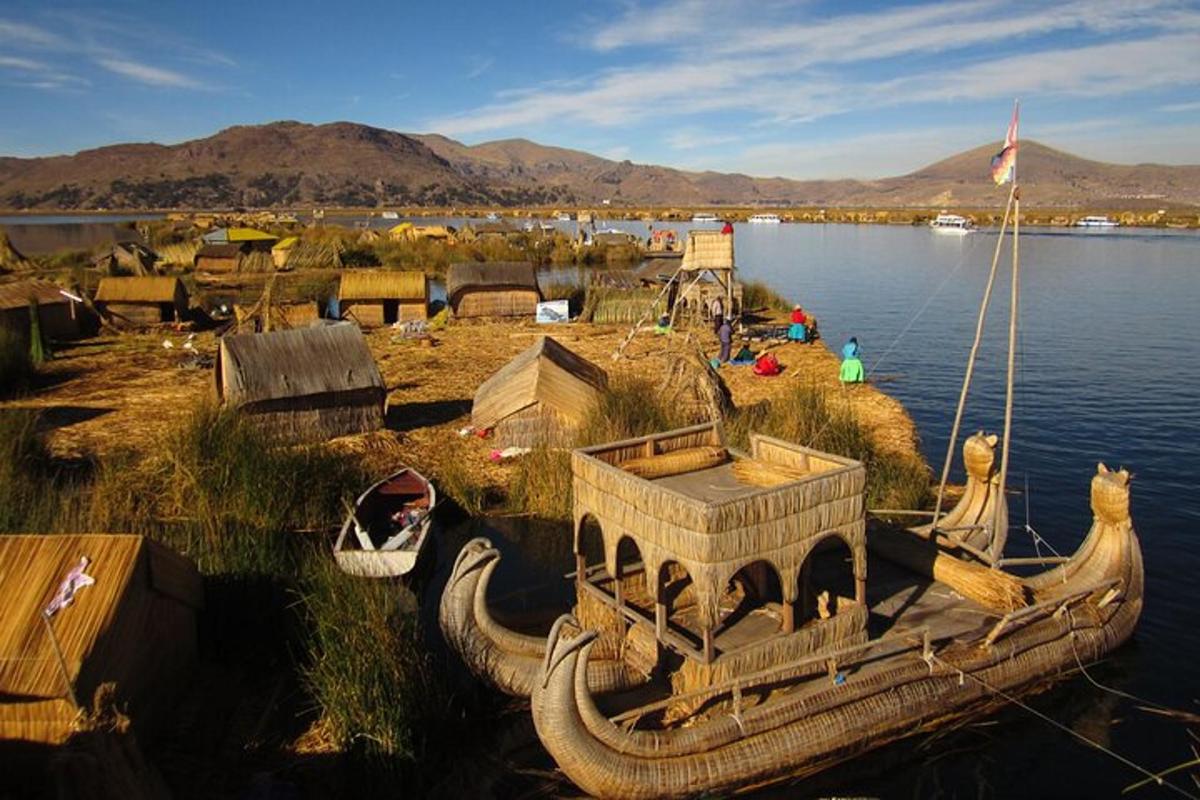 a wooden boat on the shore of a body of water