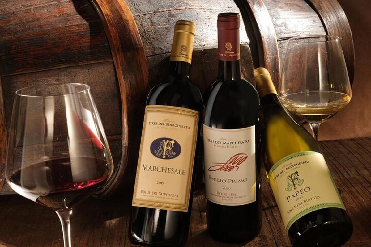 three bottles of wine sitting next to a wine glass