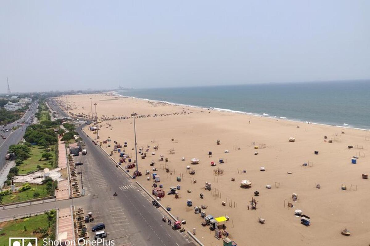 a beach with a lot of people and umbrellas