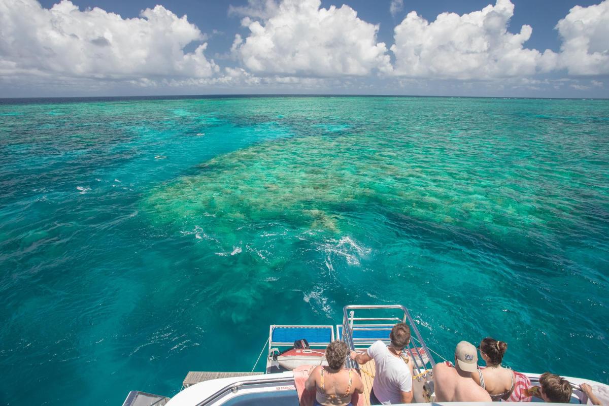 a group of people on a boat in the ocean