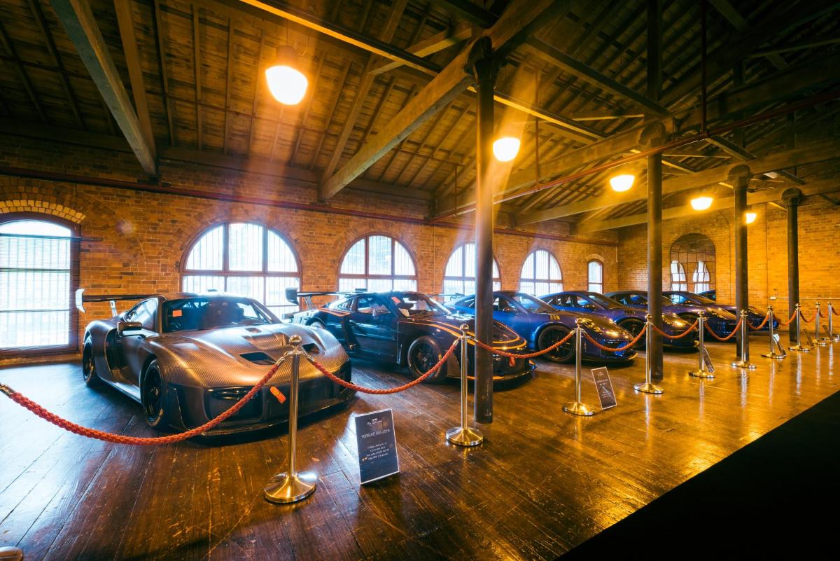 a row of cars on display in a building