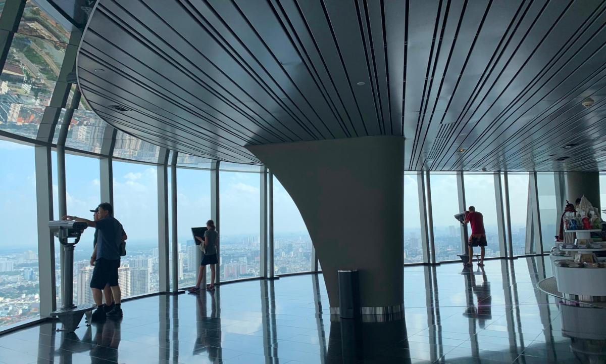 a group of people standing in a building with glass windows