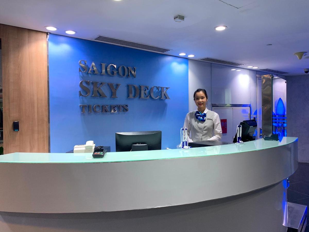 a woman is standing at a salon sky desk