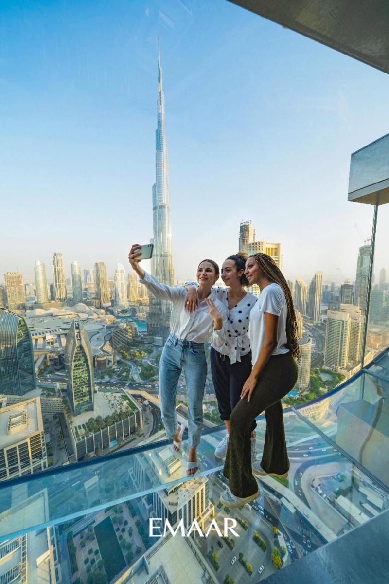 a group of people standing on the top of a skyscraper