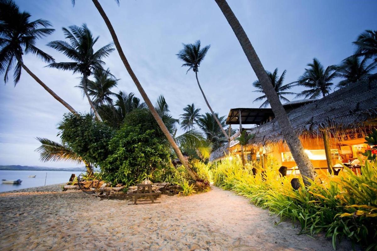 a beach with palm trees and a resort