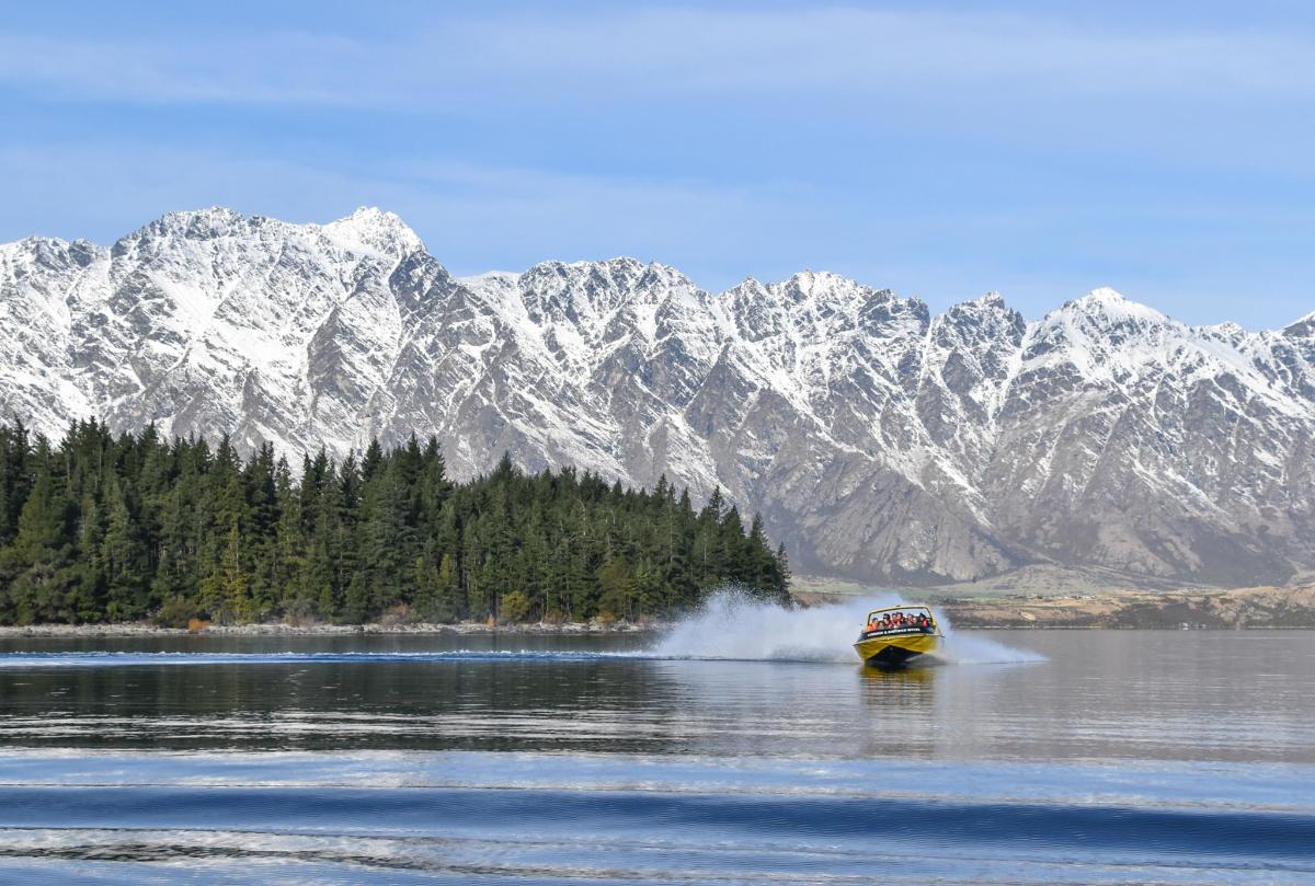 a boat in the water with mountains in the background