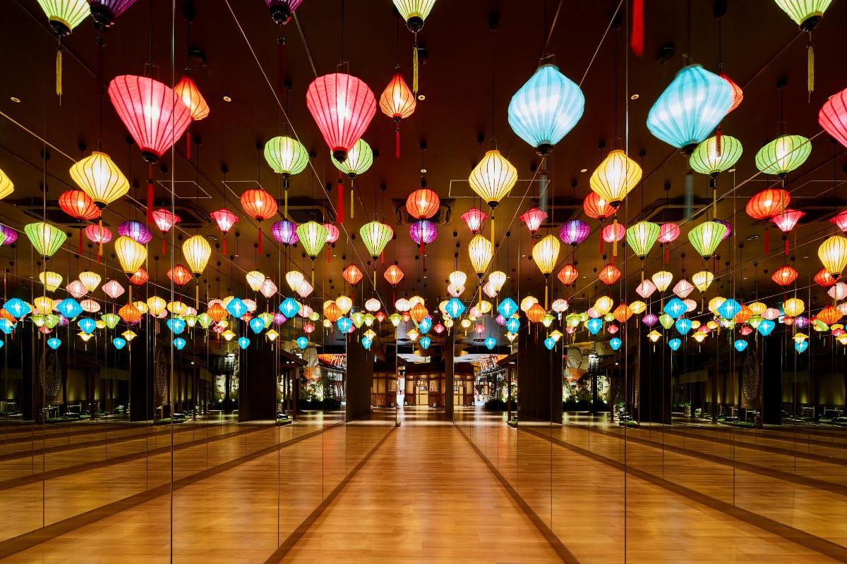 a large room with colorful paper lanterns hanging from the ceiling