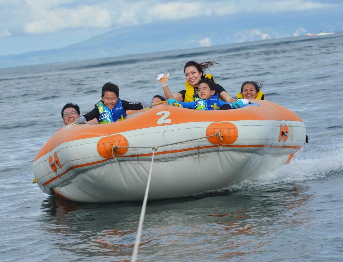 a group of children in an orange raft in the water