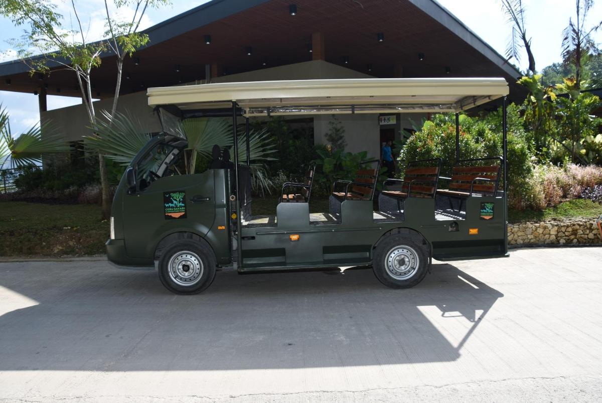 a green golf cart parked in front of a house