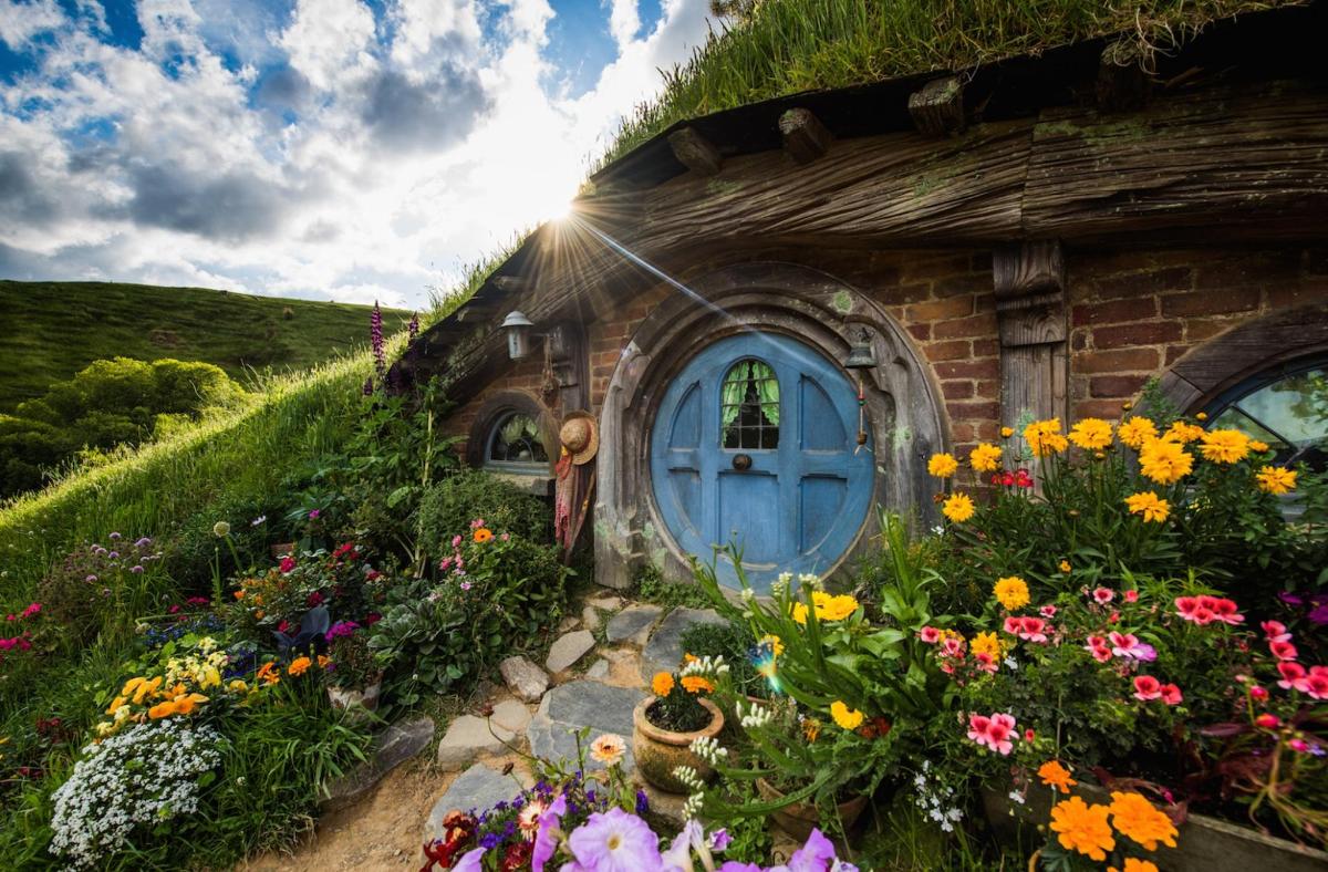 a house with a blue door and some flowers