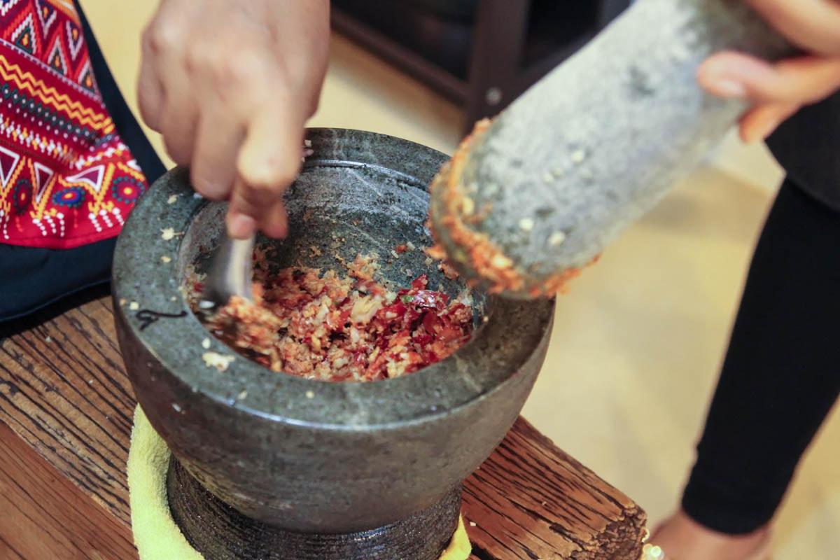 a person is mixing food in a pot