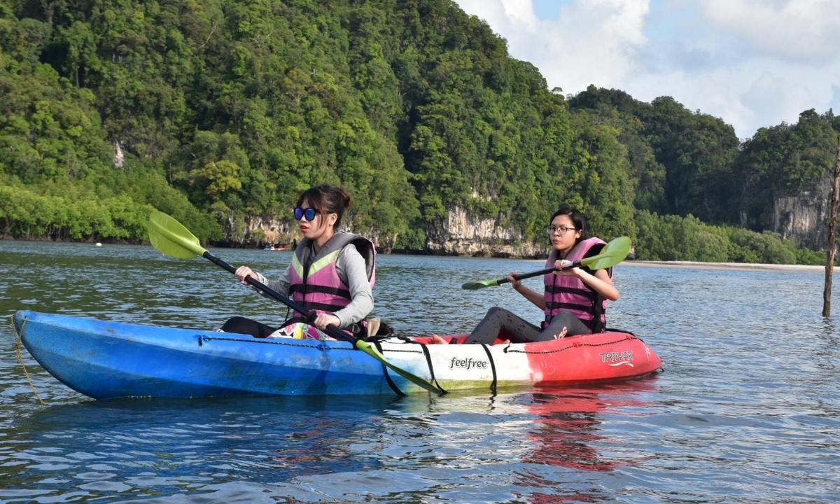 two women are sitting in a kayak on the water