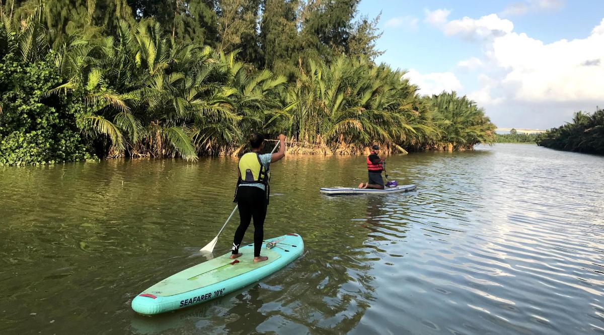 two people are on surfboards in the water