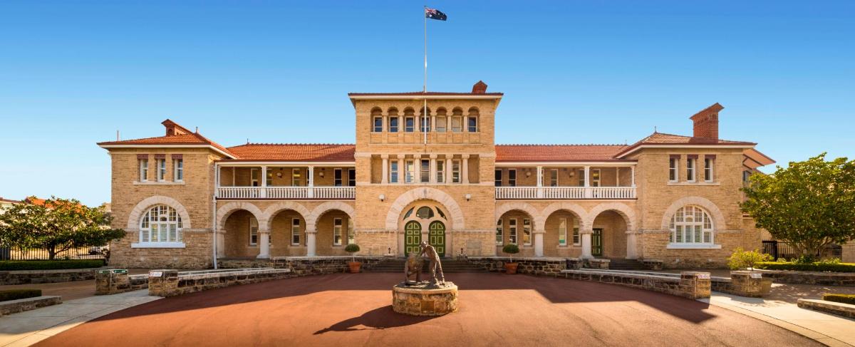 a large brick building with a fountain in front of it