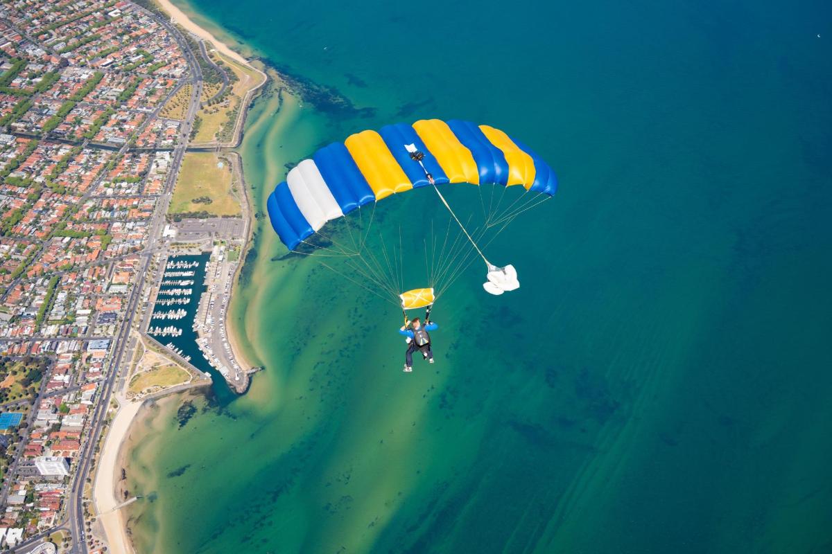 a person riding a parachute over the water