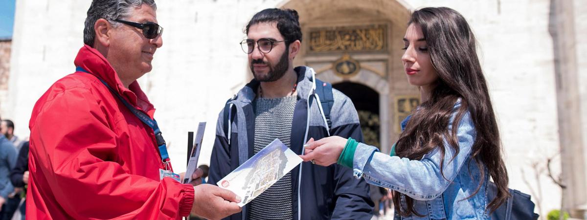 a group of three people standing next to a woman