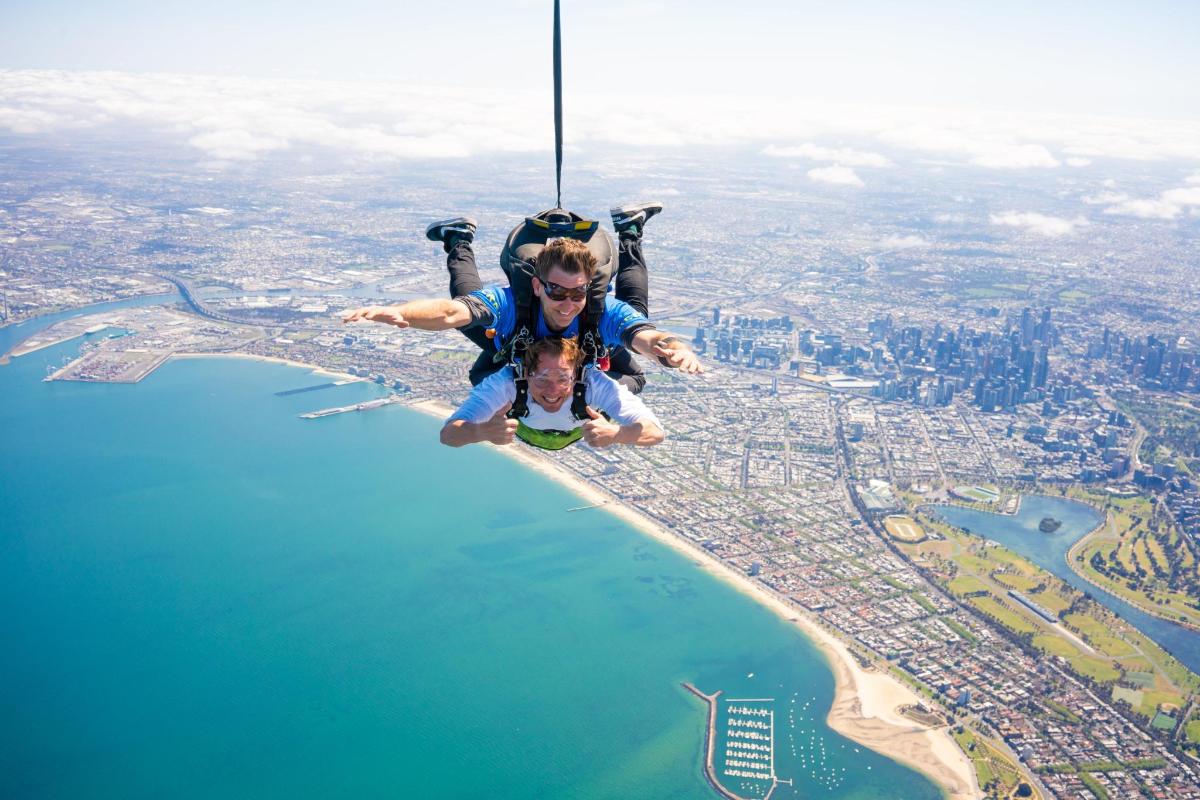a man is hanging in the air over a city