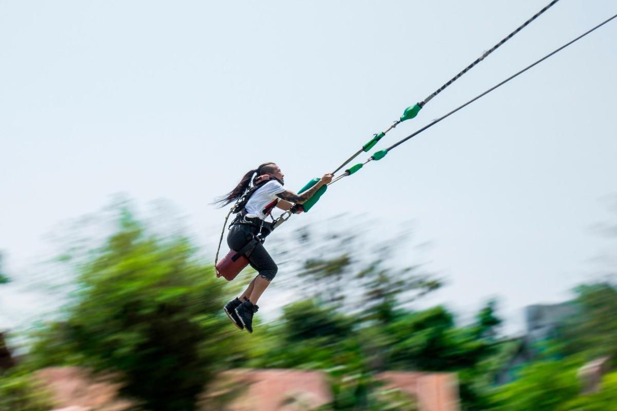 a woman on a zip line in the air